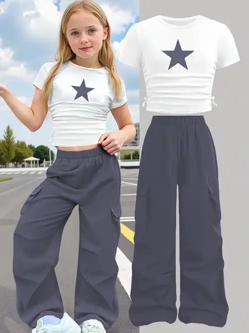 A white, short-sleeved crop top with a star graphic & dark gray or charcoal color.